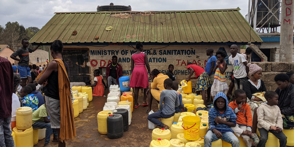 Many people queuing at a newly errected free-water point in the Kibera area in Nairobi