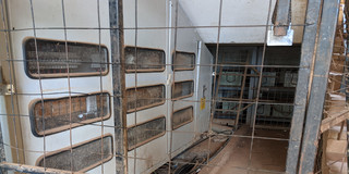 Several power meters behind bars next to a stairway in the residential compound of Canaan Estate in Nairobi