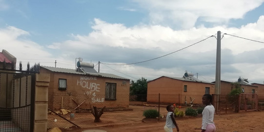 Lahee, Johannesburg, South Africa Small state-built houses at a street with children in the Lahae area in Johannesburg