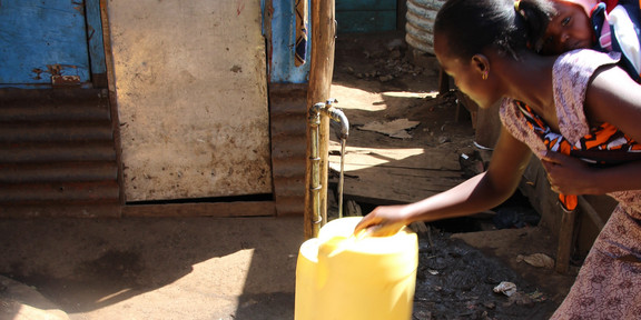 The picture shows a woman leaking water from a faucet into a container outside.