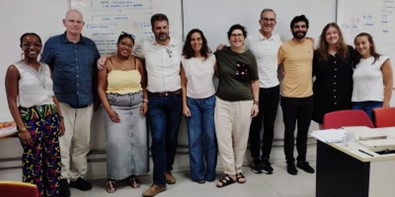 Picture of 10 people who are part of the ICOLMA research project in a room in front of a white wall in São Paulo, Brazil (2024) 