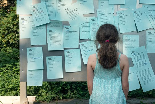 INTERPART Project, Berlin, Germany Girl in front of pin wall with notes as part of the INTERPART project in Berlin